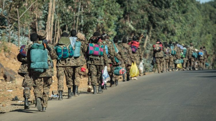 Soldiers of the Ethiopian National Defense Forse (ENDF) walk along a road in Gashena, Ethiopia. 