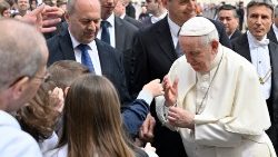 Pope Francis blesses a Rosary belonging to children