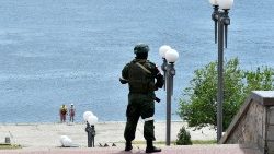 A Russian soldier patrols a river bank in Kherson