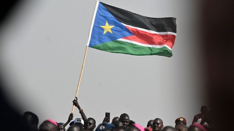 A man waves South Sudanese flag to promote peace