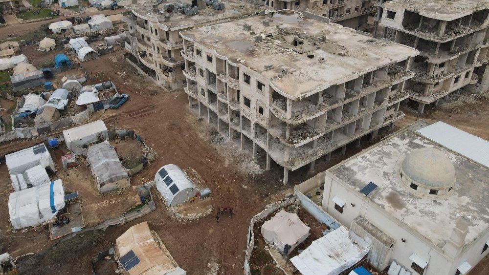 Uma vista aérea mostra prédios destruídos na cidade de Jindayris, no noroeste da província de Aleppo, em 1º de fevereiro de 2024, com as tendas da agência infantil da ONU, UNICEF, em primeiro plano para os deslocados após o grande terremoto do ano passado que atingiu a área. (Foto de Aaref WATAD/AFP)