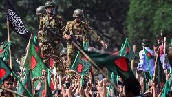 Bangladesh army personnel stand guard as anti-government protesters march to PM Sheikh Hasina's residence