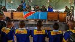 Defendants accused of belonging to the M23 rebel group stand in a DRC military court
