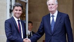 Newly appointed PM Michel Barnier shakes hands with outgoing PM Gabriel Attal during handover ceremony