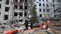 Police examine commerical and office buildings destroyed by a Russian strike on the centre of Kharkiv