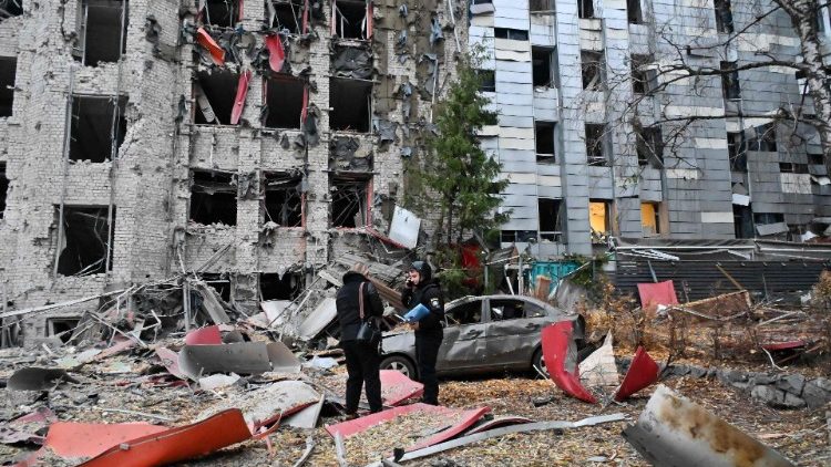 Police examine commerical and office buildings destroyed by a Russian strike on the centre of Kharkiv