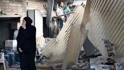  A woman reacts as she checks the damage following a reported Israeli strike in the Mazzeh district of Damascus on November 14, 2024