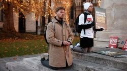  Campaigners against the assisted suicide bill kneel in prayer after the bill to legalise euthanasia in the UK is passed