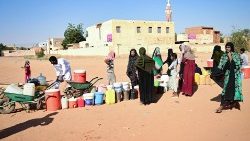 People queue for water in Omdurman, the Sudanese capital's twin city