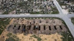 An aerial picture taken on April 18, 2022 shows coffins being buried during a funeral ceremony at a cemetery in Bucha, Ukraine, amid the Russian invasion.