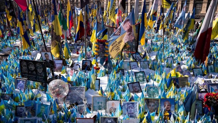 Retratos de soldados e bandeiras ucranianas expostos no Memorial for the Fallen na Independence Saquere Maidan, em Kiev, no terceiro aniversèario da invasão russa em grande escala. (Photo by Bo Amstrup/NTB/AFP)