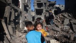 Palestinian children inspect the rubble at the Nuseirat refugee camp in central Gaza