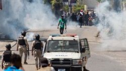 Protesters face police as they are dispersed by tear gas in Port-au-Prince, Haiti, on March 27, 2025.