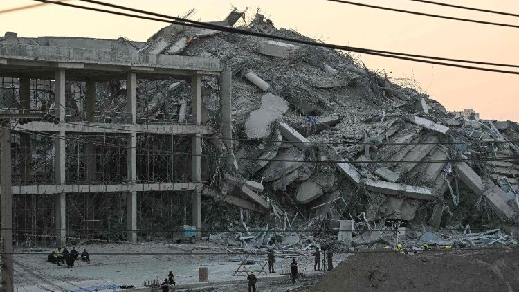 Emergency services crew survey the site of a collapsed building in Bangkok