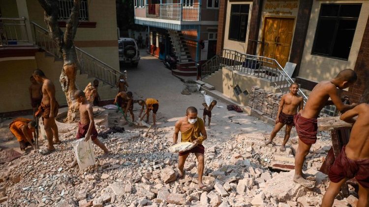 म्यांमार में  आये विनाशकारी भूकंप  से  बर्वाद हुए घरों के मलवे को हटाते हुए बौद्ध भिक्षु