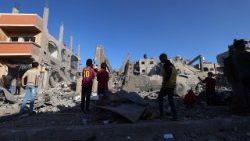 Palestinians inspect the damage, following overnight Israeli strikes