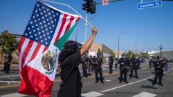 A protestor in Los Angeles holds a joint US-Mexican flag