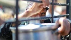 An elderly Palestinian man waits to get rice from a charity kitchen providing food for free in the west of Gaza City