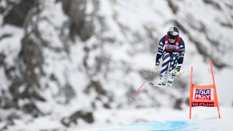 An Olympic athlete competes in a women's downhill race