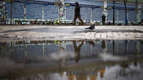A person walks alongside the Wall of Remembrance of the Fallen for Ukraine in Kyiv