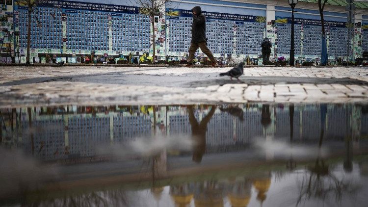 A person walks alongside the Wall of Remembrance of the Fallen for Ukraine in Kyiv