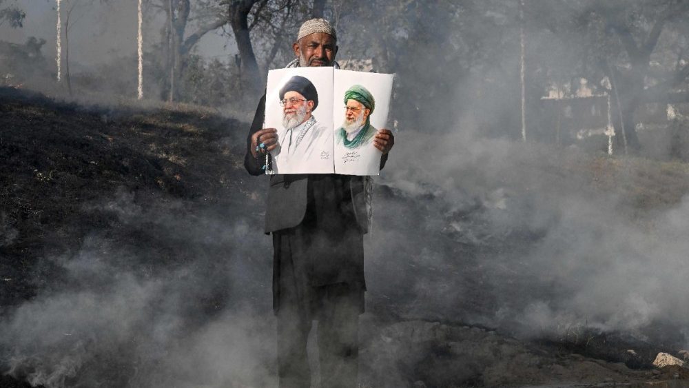 Um muçulmano xiita segura retratos do falecido líder supremo do Irã, o aiatolá Ali Khamenei, enquanto tentam invadir a embaixada dos EUA em Islamabad em 1º de março de 2026, após a morte do líder supremo iraniano Khamenei em meio a ataques EUA-Israel. Pelo menos nove pessoas foram mortas durante protestos pró-Irã no consulado dos Estados Unidos na megacidade paquistanesa de Karachi em 1º de março, de acordo com um balanço hospitalar visto pela AFP. (Foto de Aamir Qureshi / AFP)