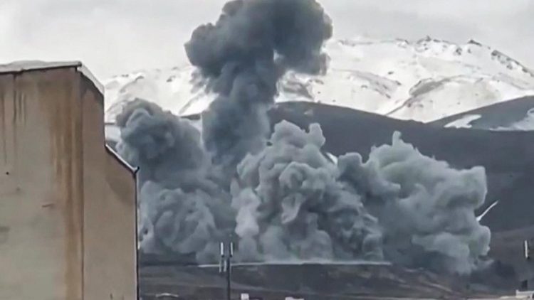 Smoke from an attack rises from the side of a mountain in Hamedan, western Iran