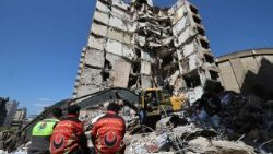 Lebanese rescuers clear the rubble at the site of an Israeli airstrike that targeted a building on April 8 in Beirut
