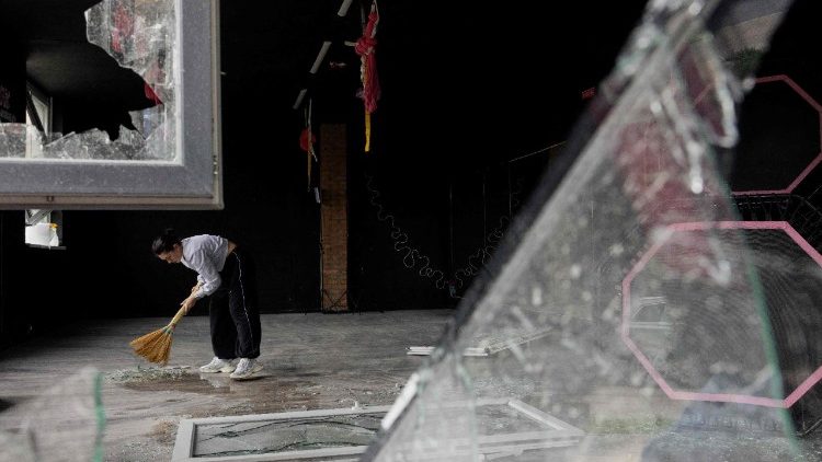 Uma menina usa uma vassoura para limpar os cacos de vidro de uma janela quebrada ap&oacute;s um ataque russo em Kiev, em 16 de abril de 2026, em meio &agrave; invas&atilde;o russa da Ucr&acirc;nia. Ataques russos massivos contra a Ucr&acirc;nia deixaram pelo menos 19 mortos durante a noite de 15 para 16 de abril, principalmente em Kiev e Odessa, disseram as autoridades ucranianas em 16 de abril de 2026, descrevendo esses ataques como alguns dos mais mortais das &uacute;ltimas semanas. (Foto de Tetiana DZHAFAROVA / AFP)