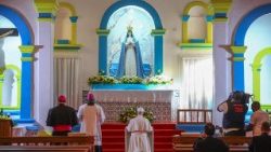 Pope Leo XIV prays inside the Church of Our lady of Muxima