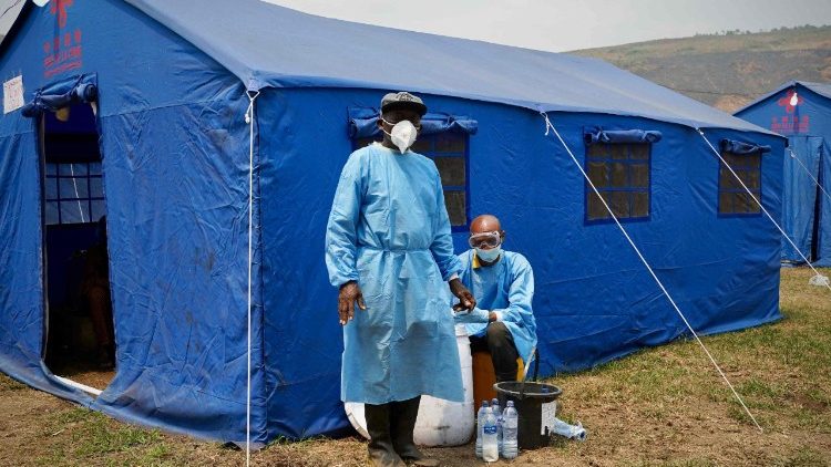 Health workers wear protective equipment at the port of Bende-Bende, in Maluku