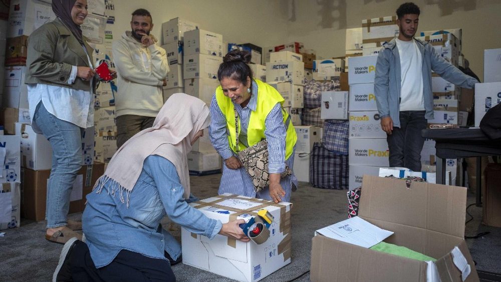 Pessoas separam e embalam suprimentos de socorro para serem carregados em um caminhão após uma campanha espontânea de arrecadação de fundos dos vizinhos e coleta de suprimentos de ajuda para as vítimas do terremoto no Marrocos, em Enschede, Holanda, no final de 13 de setembro de 2023. EPA/VINCENT JANNINK