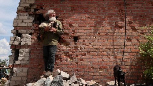 A Ukrainian man stands on the rubble of a damaged building in Orikhiv in the Zaporizhia region