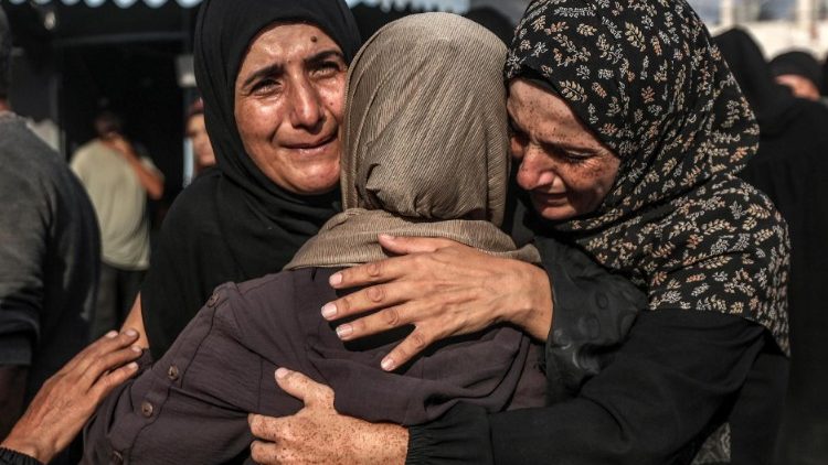 Palestinians mourn their dead after Israeli strike on mosque in Deir al-Balah, central Gaza