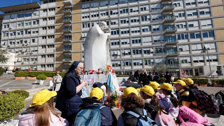 Children pray for the Pope's health outside the Gemelli hospital
