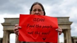 Woman holds a sign as she attends a protest against the conflict in Sudan in Berlin, Germany, 15 April 2025.