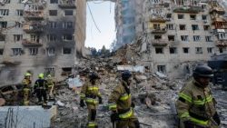 Rescuers in Kyiv search the rubble of an apartment building struck by Russian airstrikes earlier this week