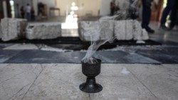 Incense burns during a vigil for the victims of a suicide bomber at Mar Elias Church