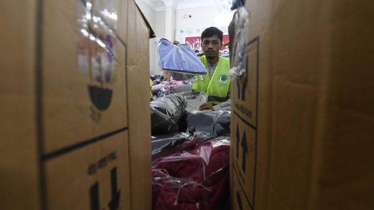 PMML party volunteers prepare clothing for flood victims in Pakistan