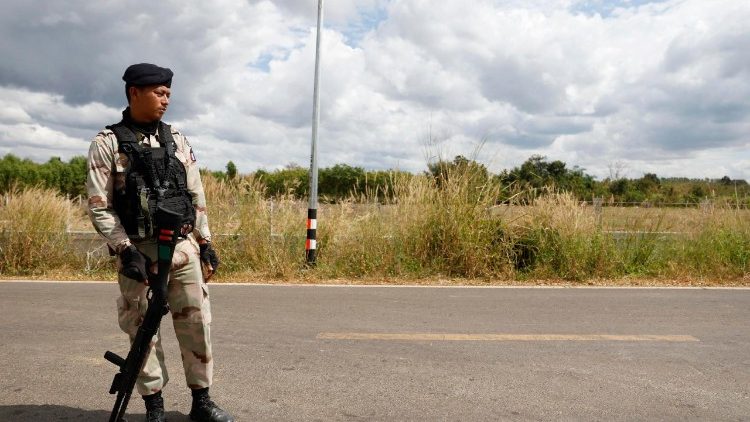 An armed Thai security forces personnel stands guard during clashes with Cambodian troops in Phanom Dong Rak district, Surin province, Thailand