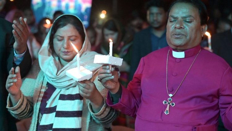 Pakistani Christians light candles as they gather during Christmas celebration