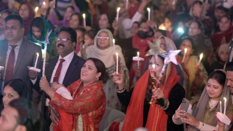 Pakistani Christians light candles as they gather during Christmas celebrations in Lahore