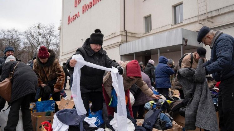 Ukrainian volunteers distribute free humanitarian aid, including food, hygiene products, and clothing, to local people near a local church in Kramatorsk