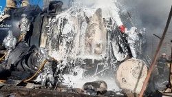 Firefighters work to put out a fire in a thermal power plant damaged by a Russian missile strike in Zhytomyr