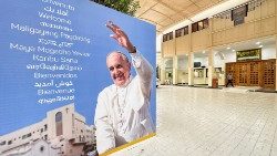 Welcome banners are displayed for Pope Francis at Sacred Heart Catholic Church in Manama