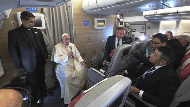 Pope Francis attends a press conference aboard the papal plane returning from Mongolia