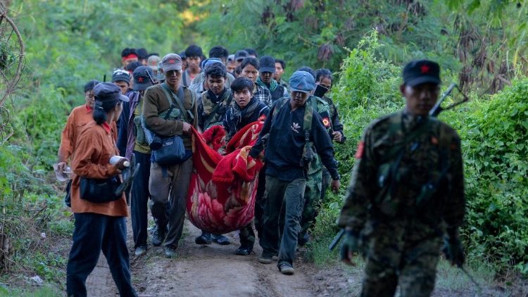 People's Liberation Army PLA members carry an injured person near Sagaing Region in Myanmar
