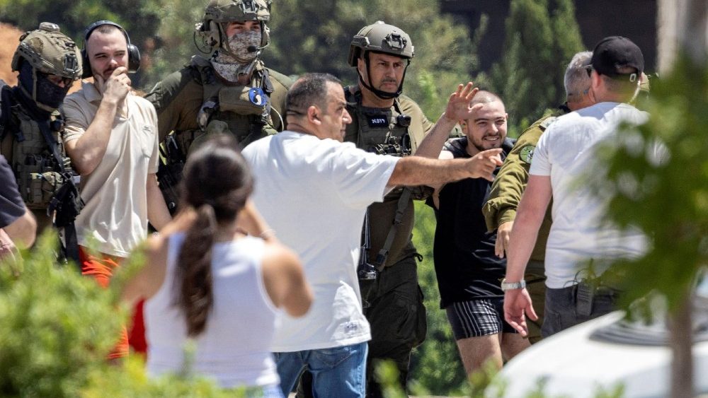 Released hostages Andrey Kozlov and Almog Meir Jan are escorted, in Ramat Gan