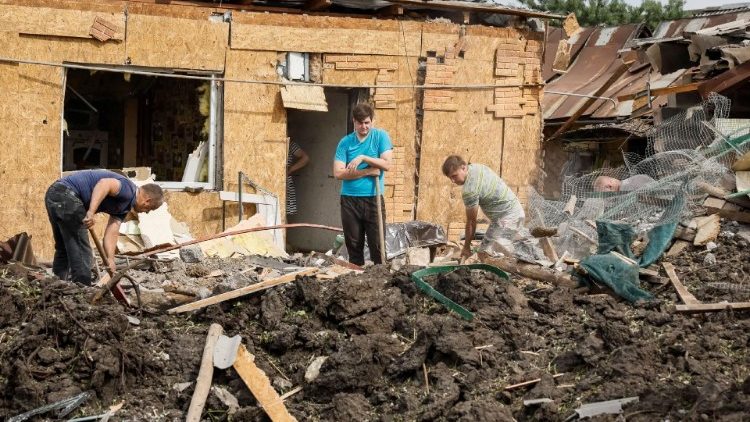 Pessoas limpam as ruínas de um edifício residencial destruído no local de um ataque com mísseis russos, em meio ao ataque da Rússia à Ucrânia, em Pokrovsk, região de Donetsk, Ucrânia, 24 de junho de 2024. REUTERS/Alina Smutko