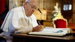 FIle photo of Pope Francis signing a text
